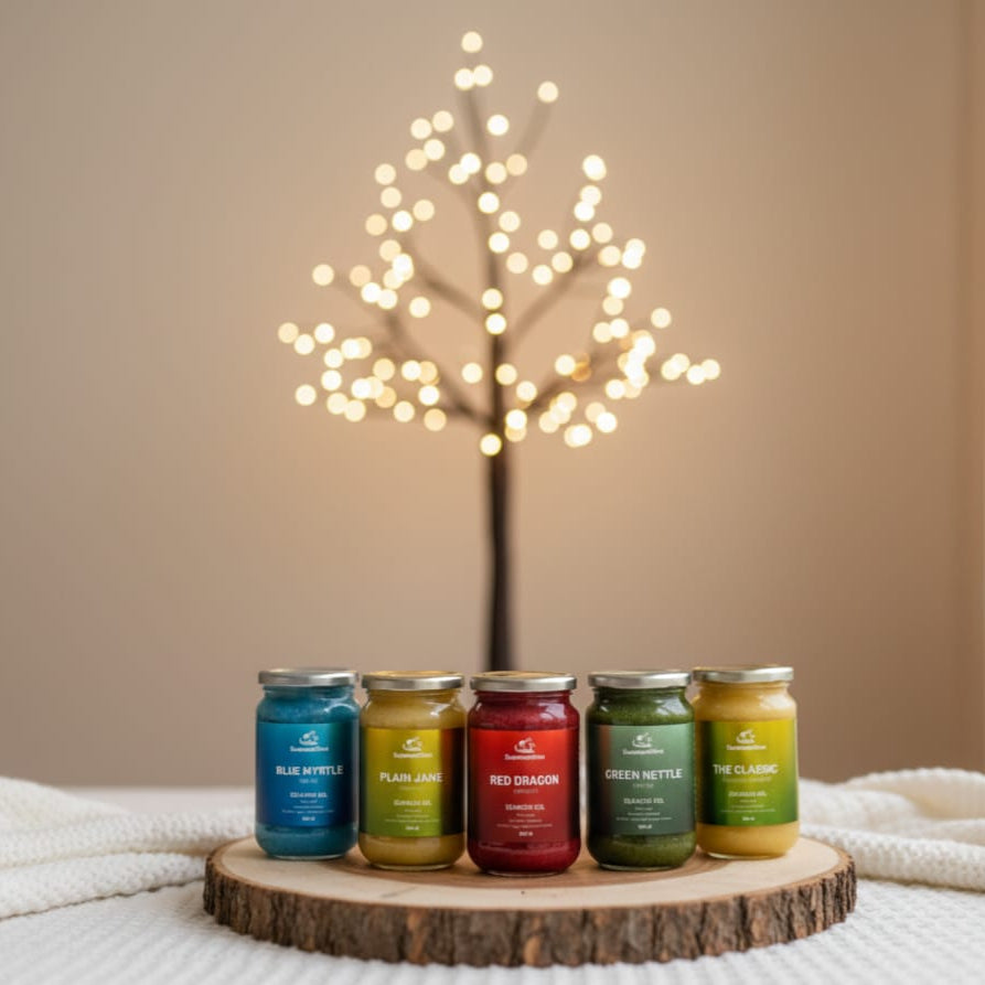 Five jars of different colors on a wooden stand with a softly lit tree in the background.
