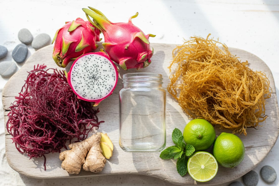 Wooden board with dragon fruit, seaweed, ginger, lime, and a jar on a light background